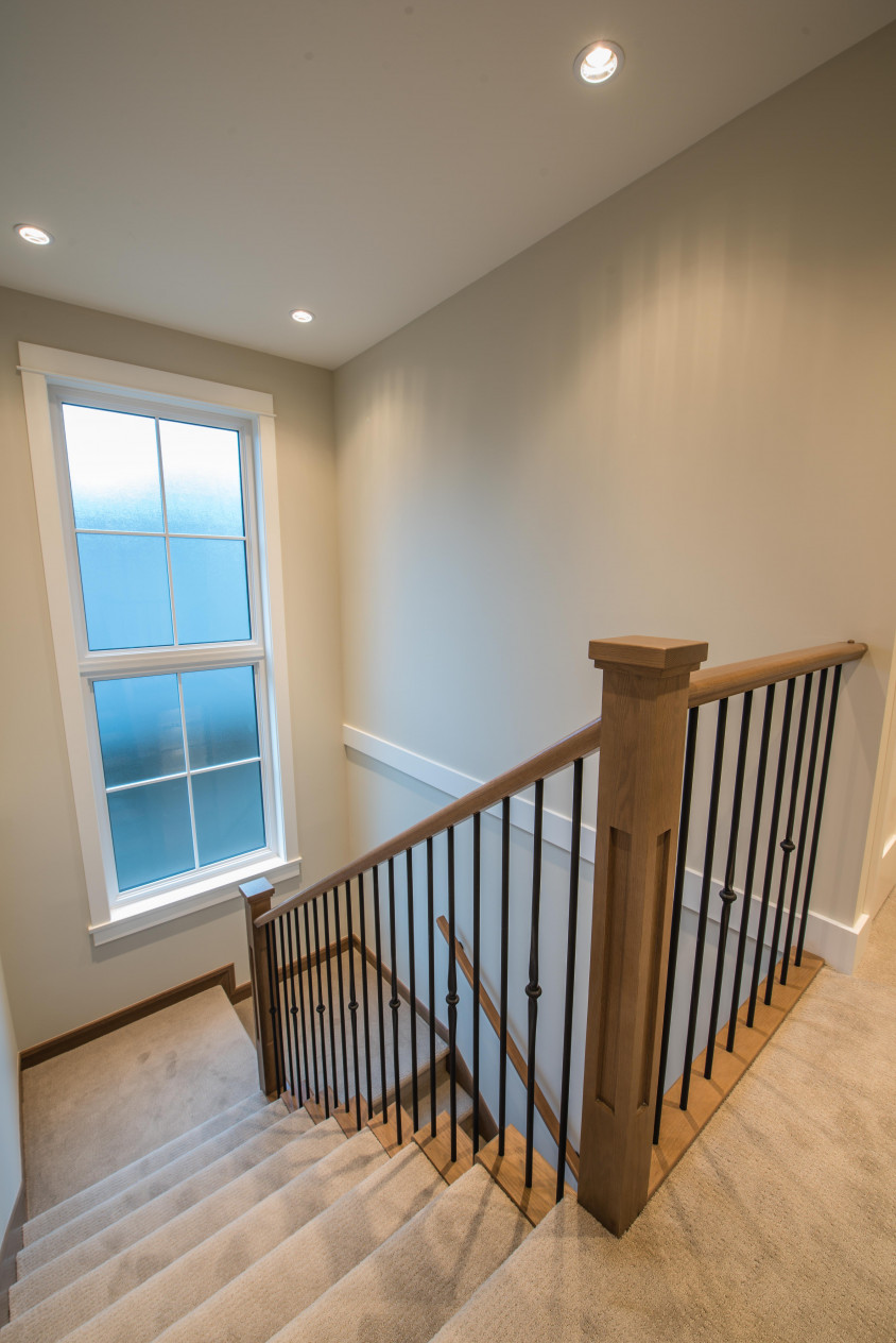 Vinyltek window introduces tons of natural light to this staircase