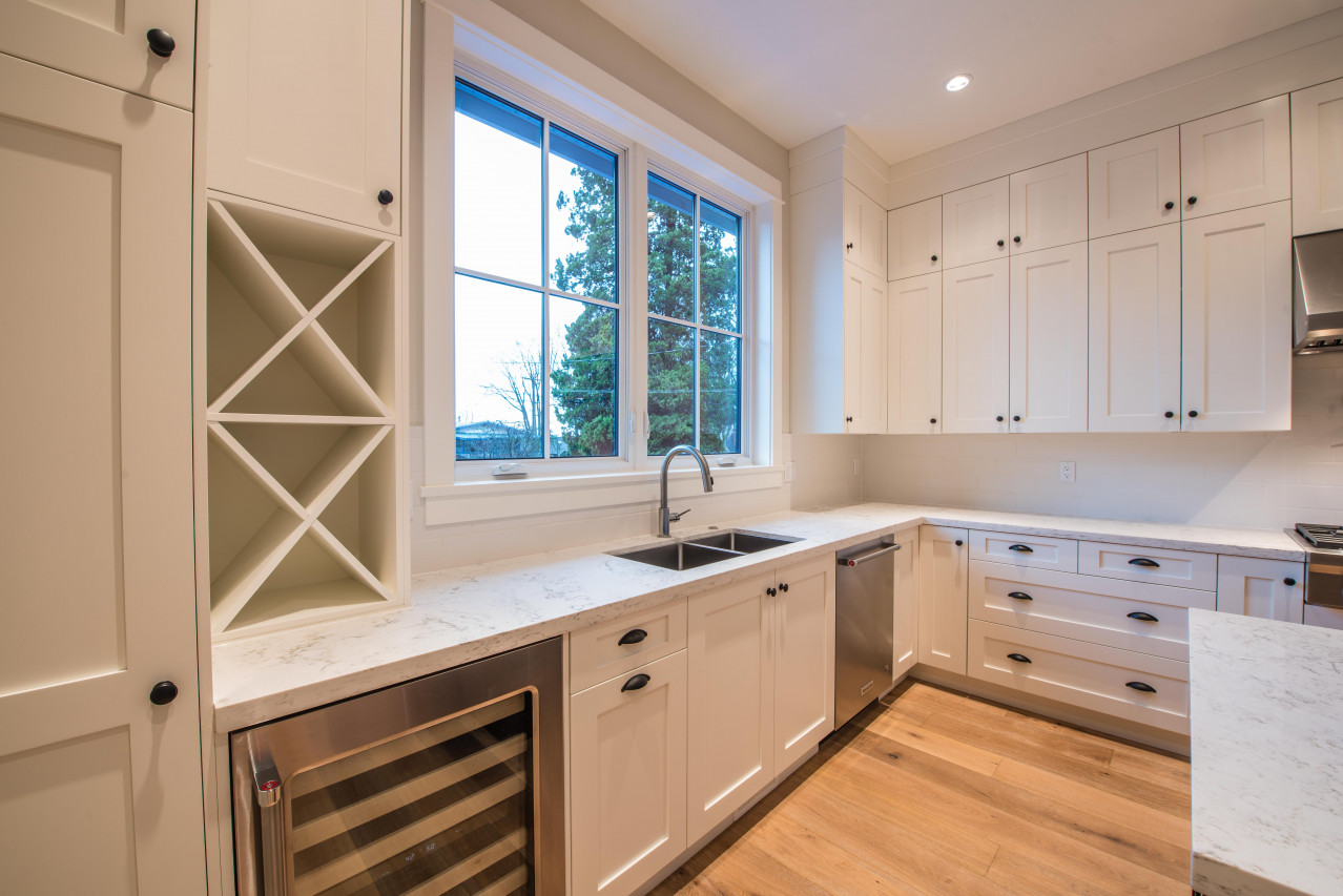 Kitchen with casement window overlooking the back yard.